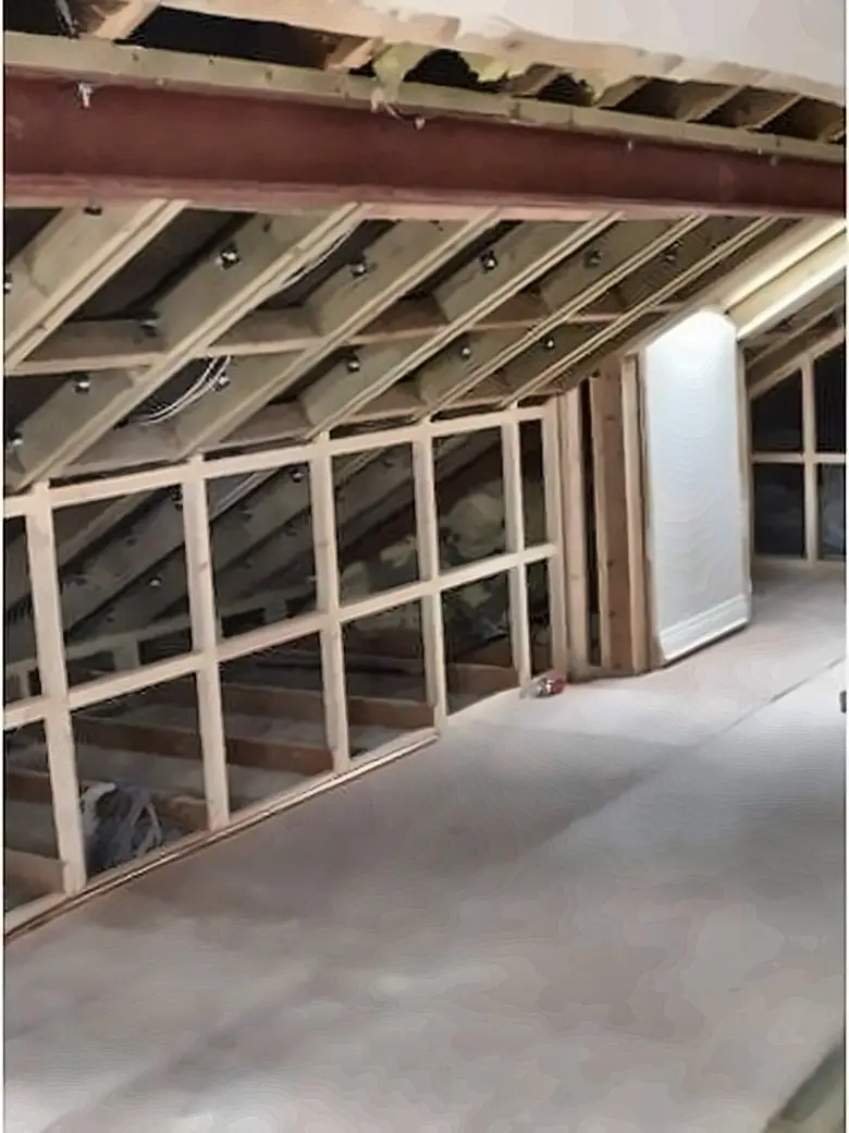 The same loft in carcass, showing studwork and roof timbers