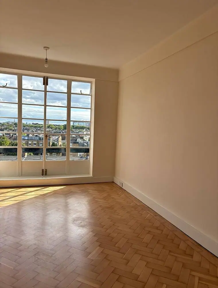 A redecorated room with parquet flooring