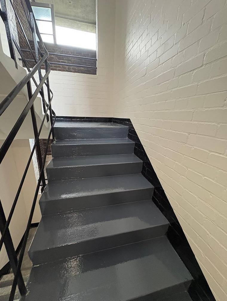 Stair and landing with repainted steel balustrade