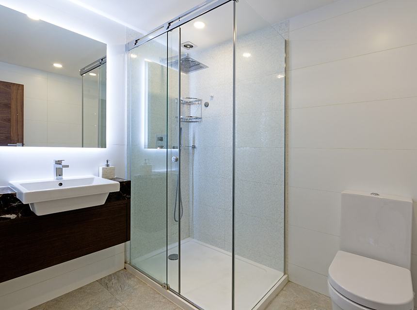 A finished bathroom with bath and fitted furniture