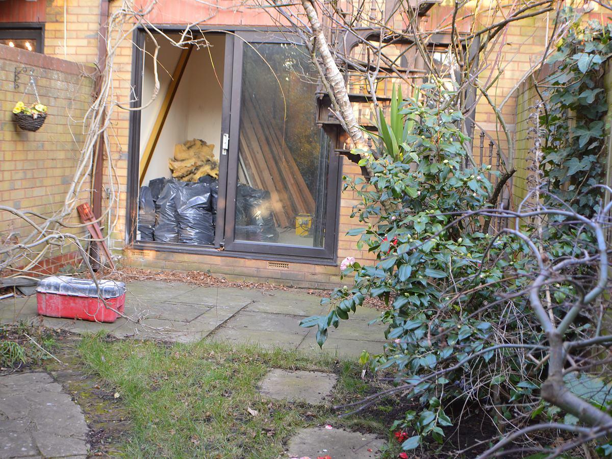 The original overgrown garden before the works
