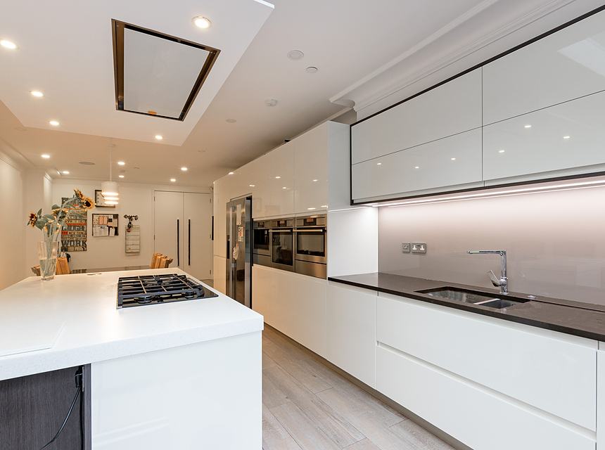 The finished kitchen with island and integrated appliances